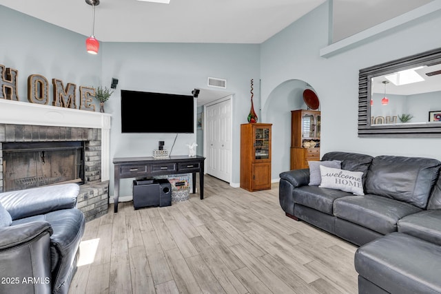 4116 E Downing St, Mesa, AZ 85205 - living room with wood finished floors, a skylight, a fireplace, and high vaulted ceiling
