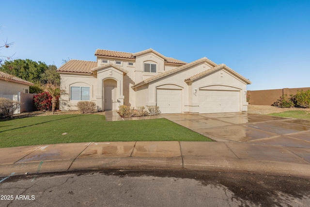 mediterranean / spanish-style house featuring a front lawn and a garage