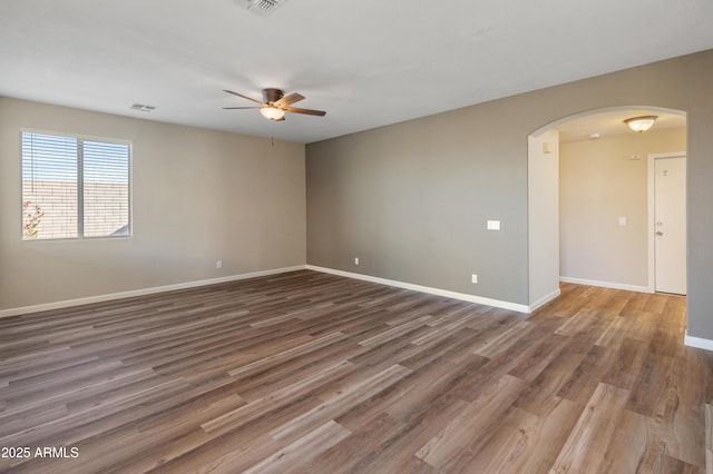 empty room with dark wood-type flooring and ceiling fan