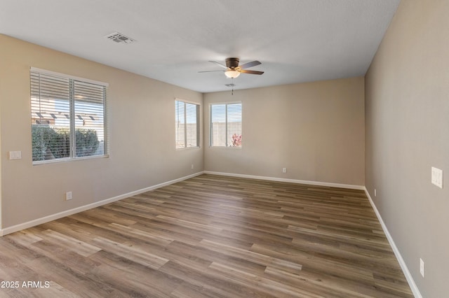 unfurnished room with ceiling fan and hardwood / wood-style flooring