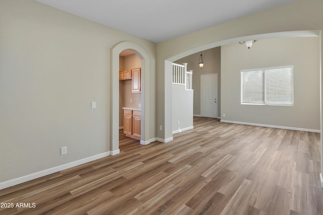 empty room with light hardwood / wood-style flooring