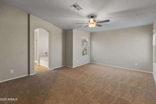 carpeted empty room with ceiling fan