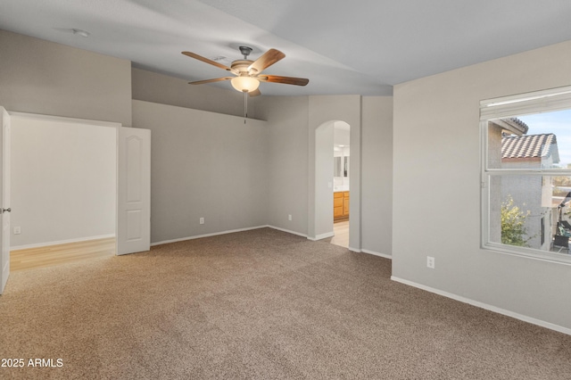 carpeted spare room with ceiling fan