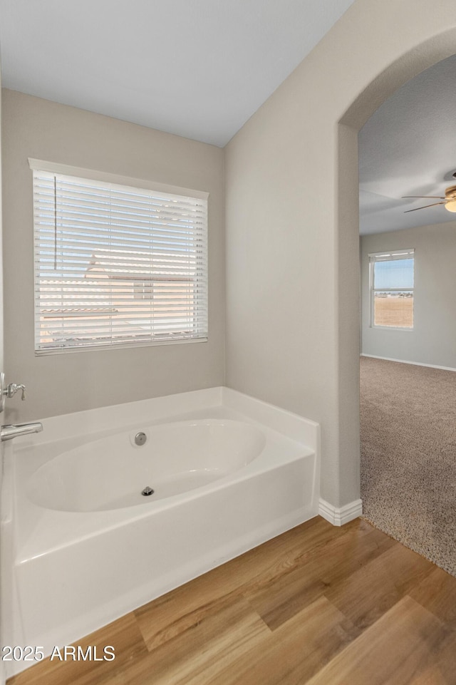 bathroom featuring hardwood / wood-style flooring and a washtub