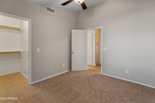 unfurnished bedroom featuring ceiling fan, a closet, and carpet flooring