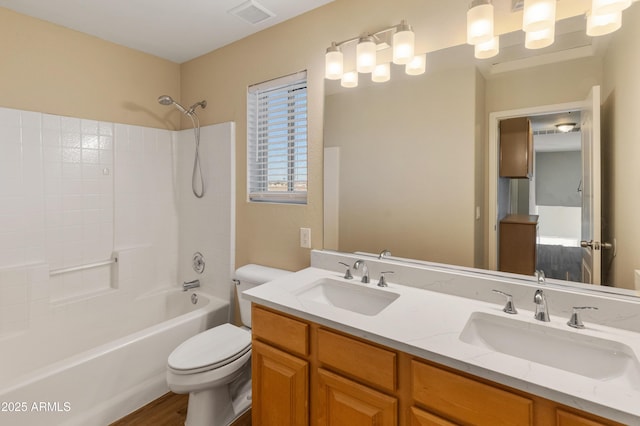 full bathroom featuring wood-type flooring, shower / bathing tub combination, vanity, and toilet