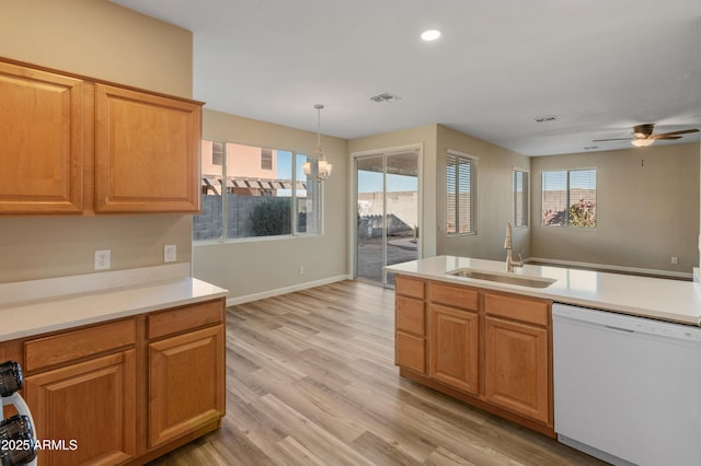 kitchen featuring decorative light fixtures, sink, white dishwasher, light hardwood / wood-style flooring, and ceiling fan with notable chandelier