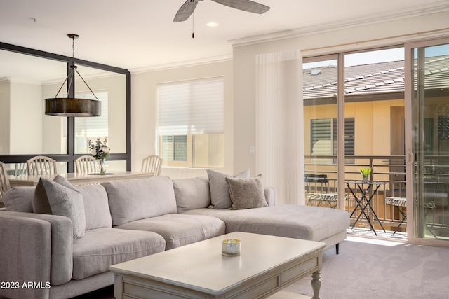 carpeted living room featuring crown molding and ceiling fan