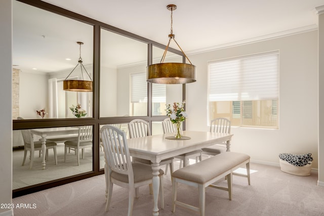 dining area featuring ornamental molding, carpet floors, and a wealth of natural light