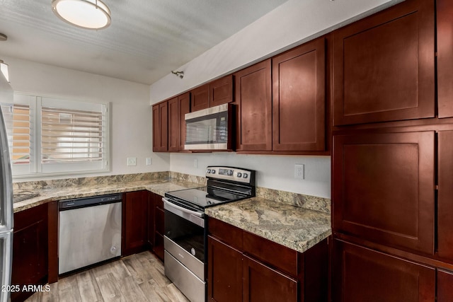154 W 5th St Unit 210, Tempe, AZ 85281 - kitchen with stainless steel appliances, light wood-type flooring, and light stone countertops