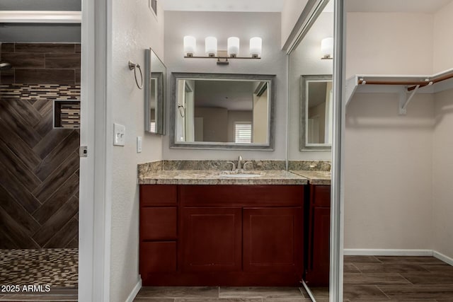 154 W 5th St Unit 210, Tempe, AZ 85281 - bathroom featuring vanity, a tile shower, and wood finished floors