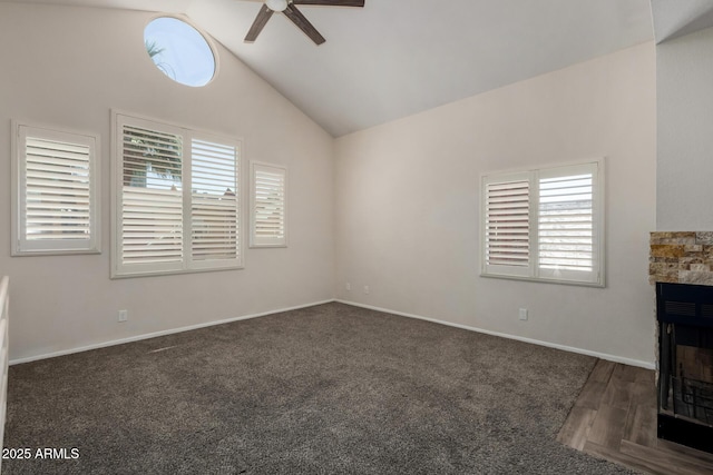 154 W 5th St Unit 210, Tempe, AZ 85281 - unfurnished living room featuring a ceiling fan, vaulted ceiling, a stone fireplace, carpet floors, and wood finished floors