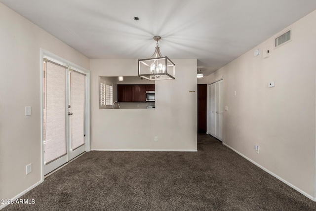 154 W 5th St Unit 210, Tempe, AZ 85281 - spare room featuring dark colored carpet and a chandelier