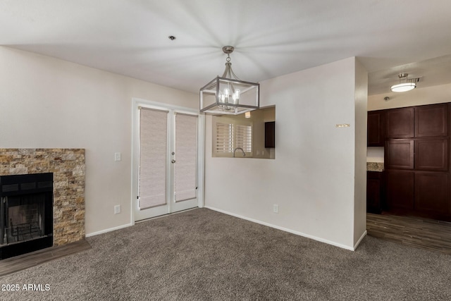154 W 5th St Unit 210, Tempe, AZ 85281 - unfurnished living room featuring carpet floors, a chandelier, and a stone fireplace