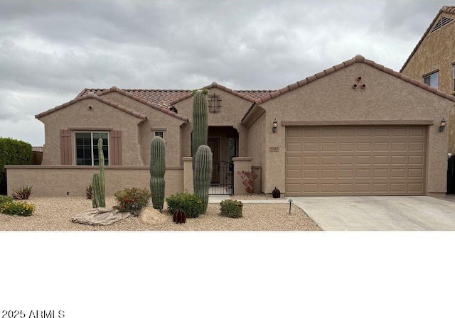 5649 E Desert Forest Trl, Cave Creek, AZ 85331 - mediterranean / spanish-style house featuring a fenced front yard, driveway, an attached garage, and stucco siding