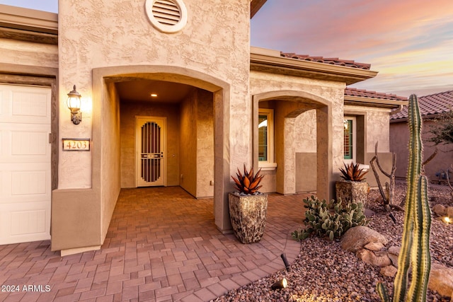 view of exterior entry at dusk