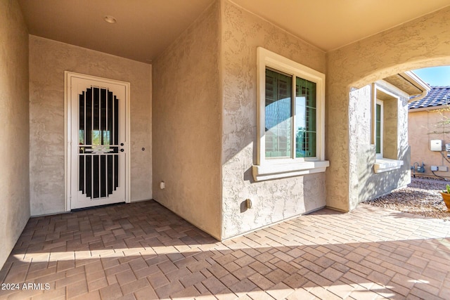 entrance to property featuring a patio area