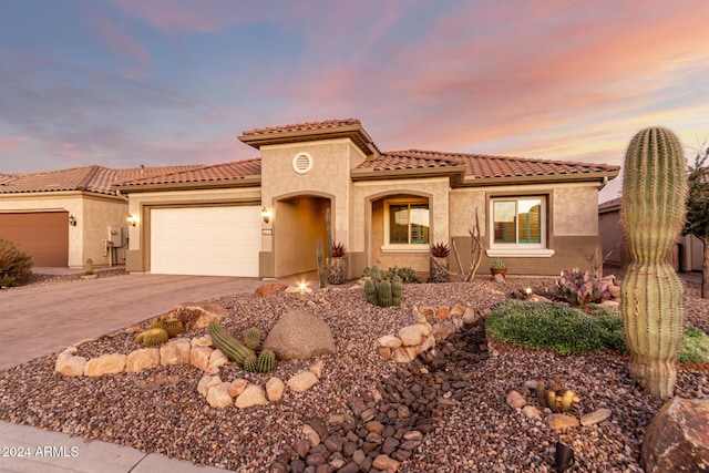 mediterranean / spanish-style home featuring a garage