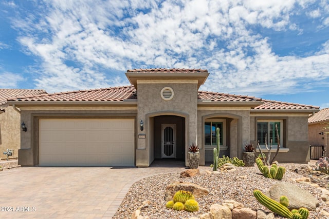 mediterranean / spanish home with a garage