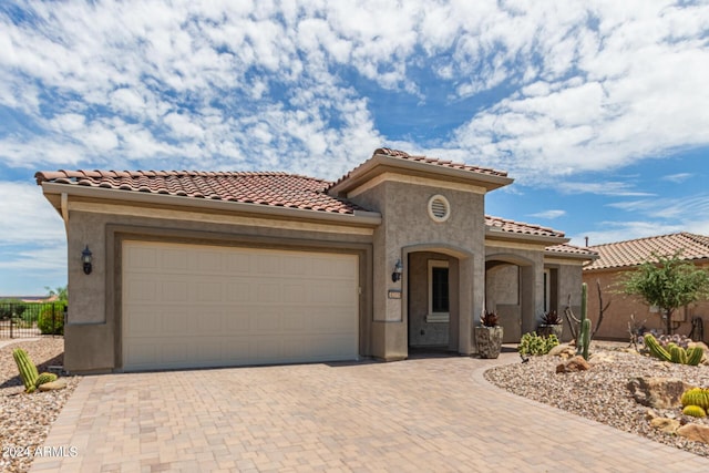 mediterranean / spanish-style house with a garage