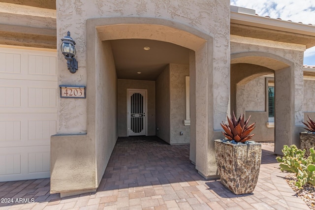 view of exterior entry with a garage