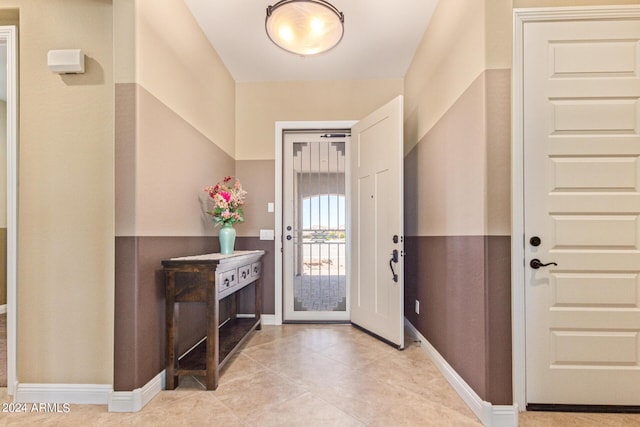 foyer entrance with light tile patterned floors