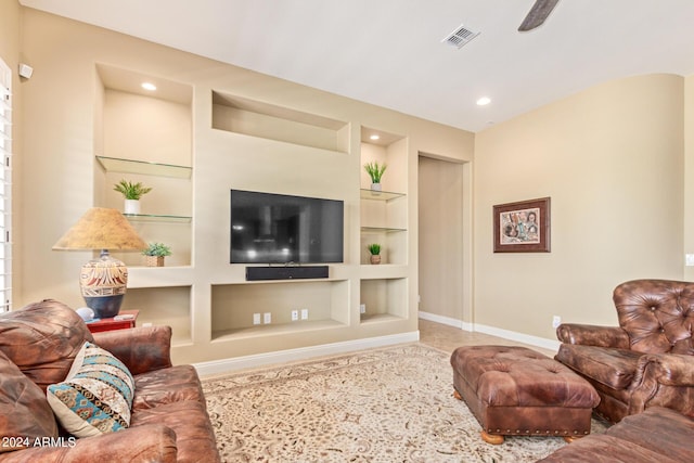 living room with ceiling fan and built in features