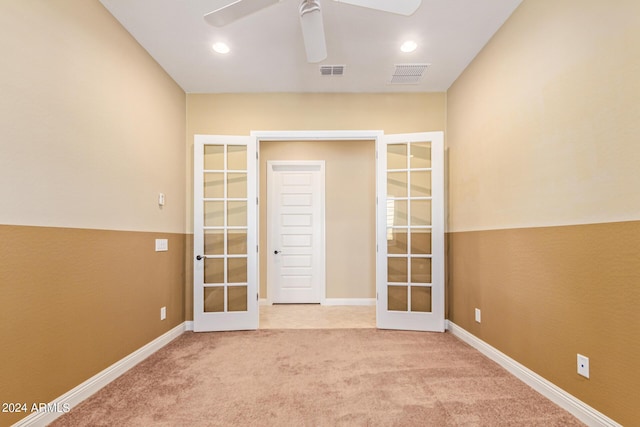 carpeted empty room featuring ceiling fan and french doors