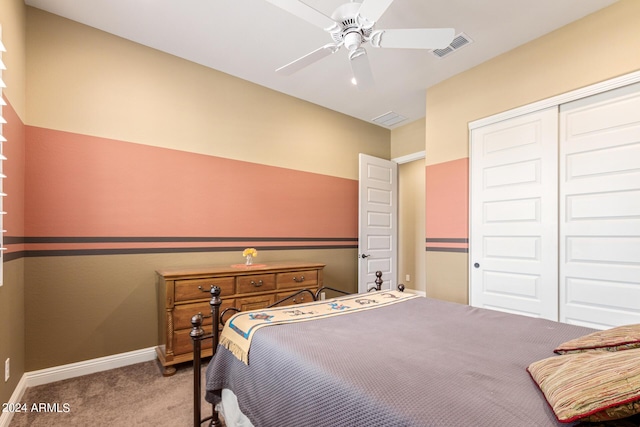 bedroom with ceiling fan, a closet, and light colored carpet