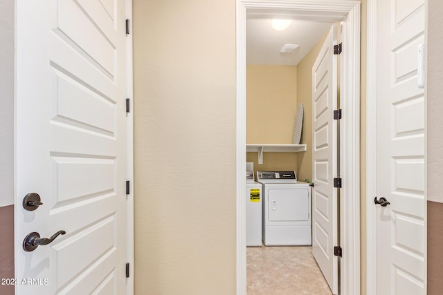 clothes washing area with washer and dryer