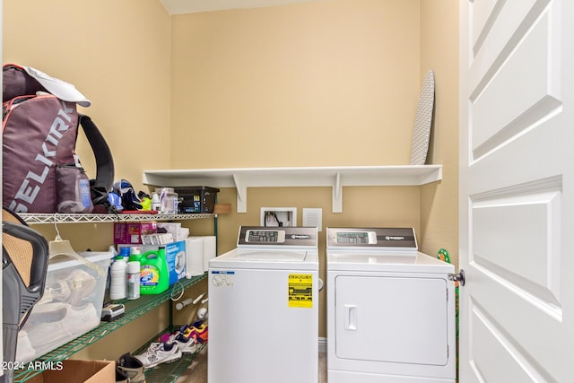 clothes washing area with washing machine and dryer