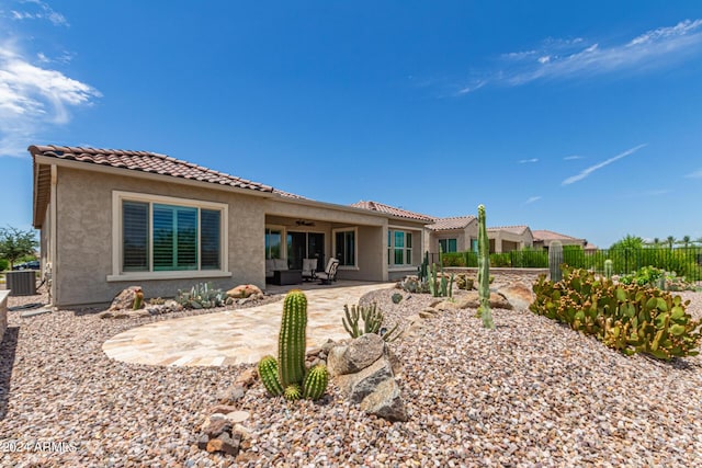 rear view of house with ceiling fan, a patio area, and central air condition unit