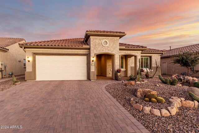 mediterranean / spanish home with a garage