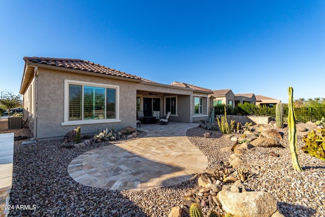 rear view of house with ceiling fan, a patio, and central AC unit