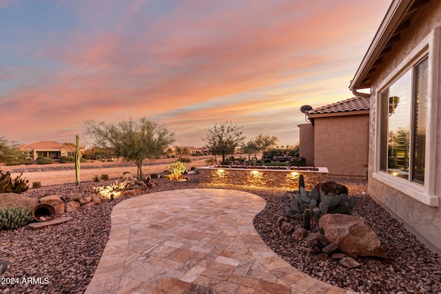 view of patio terrace at dusk