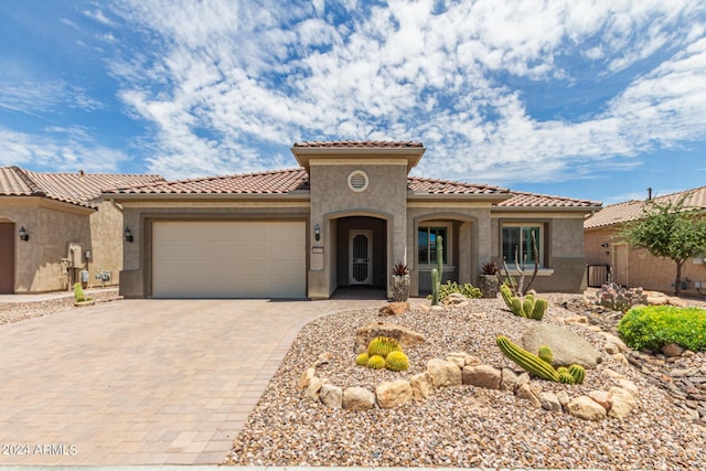 mediterranean / spanish-style home featuring a garage