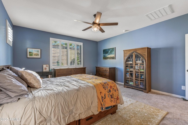 carpeted bedroom featuring baseboards, visible vents, and ceiling fan