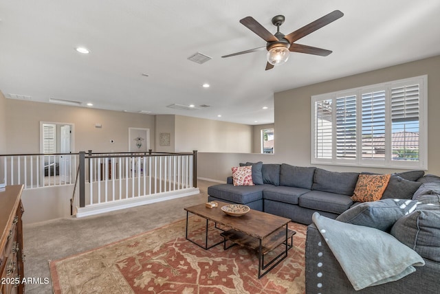 living area with carpet floors, baseboards, visible vents, and recessed lighting