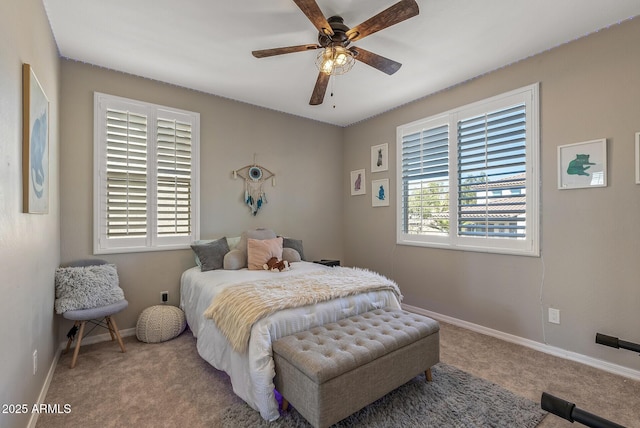 carpeted bedroom with ceiling fan and baseboards