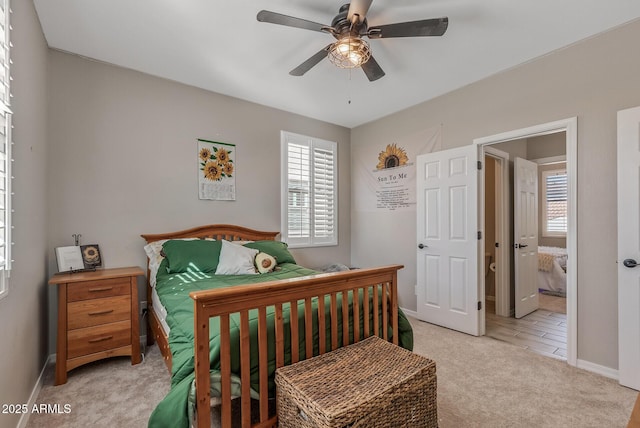 bedroom featuring ceiling fan, baseboards, and light colored carpet