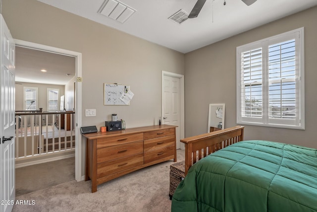 bedroom with ceiling fan, visible vents, and light colored carpet