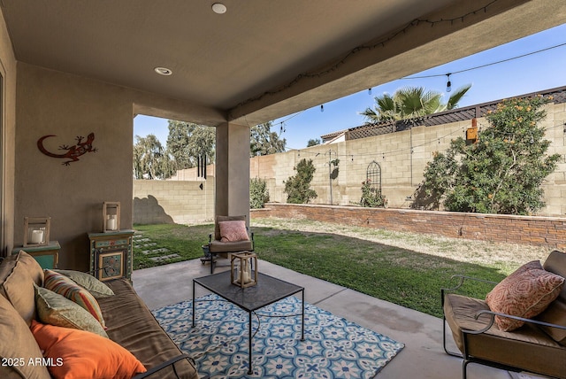 view of patio featuring a fenced backyard and an outdoor living space