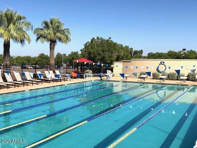 pool featuring a patio area and fence