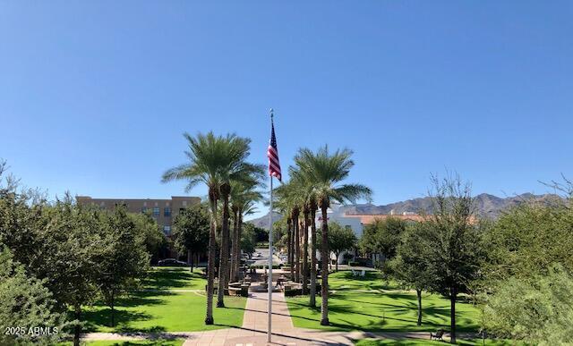 surrounding community featuring a lawn and a mountain view