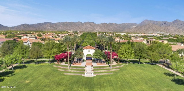 surrounding community with a lawn and a mountain view