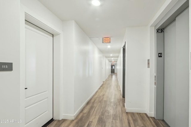 corridor featuring hardwood / wood-style floors and elevator