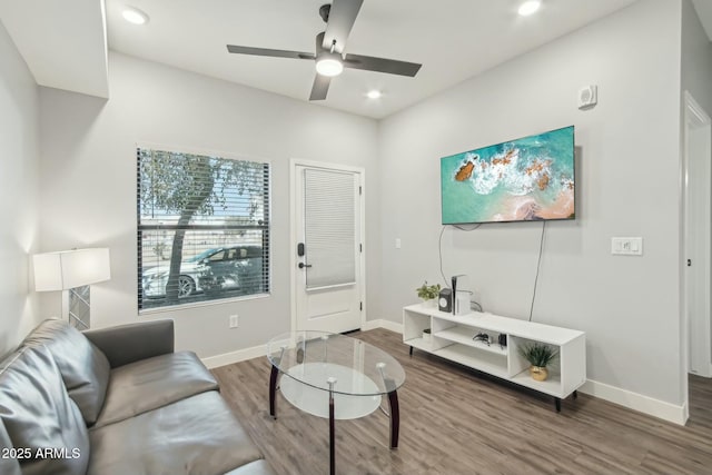 living room featuring hardwood / wood-style flooring and ceiling fan