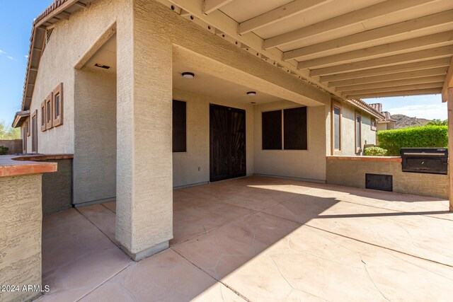 back of property featuring a patio area and a lawn