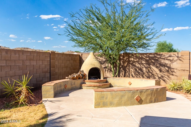 view of patio / terrace with exterior fireplace