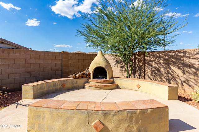 view of patio / terrace with exterior fireplace